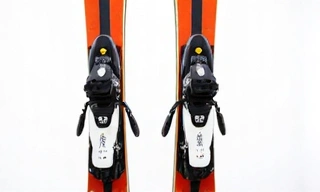 A pair of modern alpine skis with bindings, showcasing their sleek design and advanced technology.